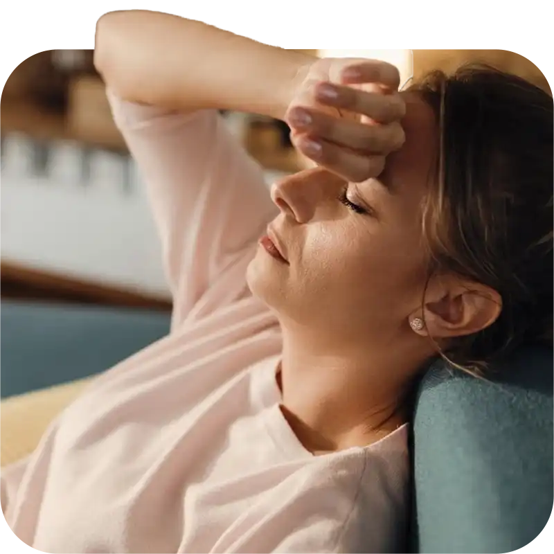 A depressed lady is lying on the couch who deserves counseling.